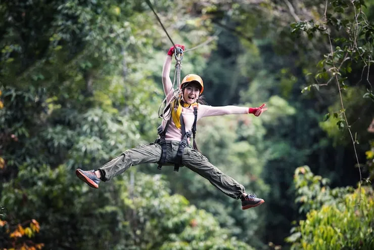 Person bungee jumping off a bridge over Tana River