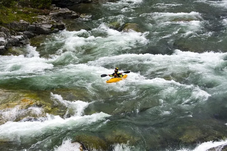 Group white water rafting through rapids on Tana River